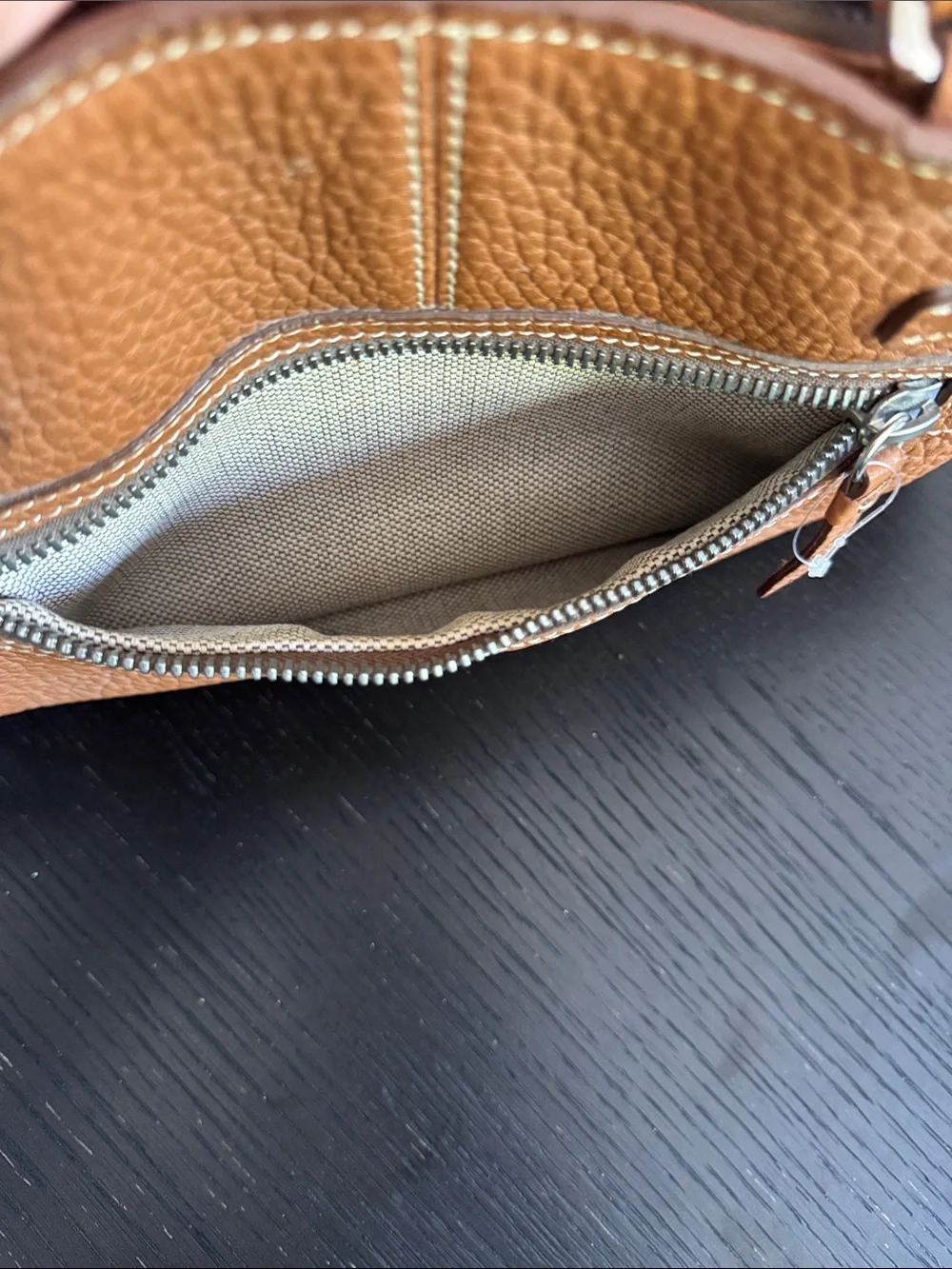 Dooney & Bourke tan pebbled leather side pockets belted satchel bag.